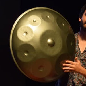 Close-up of Ashim Bery's handpan, its tone fields catching the stage light